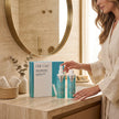 Mujer junto al pack Hair Care Bioplex Nº1 y Nº2 de Valquer para el cuidado del cabello dañado.
