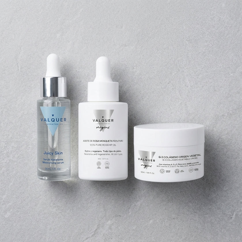 Pack Reparación Intensiva de Valquer con crema de colágeno, sérum de rosa mosqueta y sérum hidratante sobre fondo gris