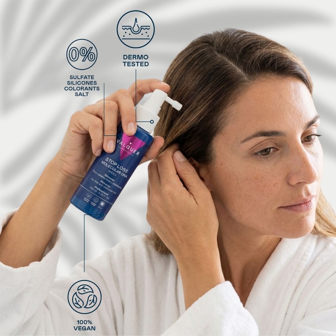 Mujer aplicando el sérum anticaída Stop Loss Molecular DNA Shock Valquer en el cuero cabelludo, fórmula 100% vegana y dermatológicamente testada